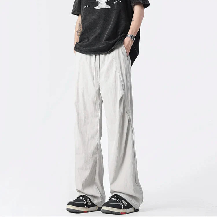 Pantalon Parachute Tufté En Nylon Léger Froissé Avec Cordons Chromés Et Coupe Large Décontractée